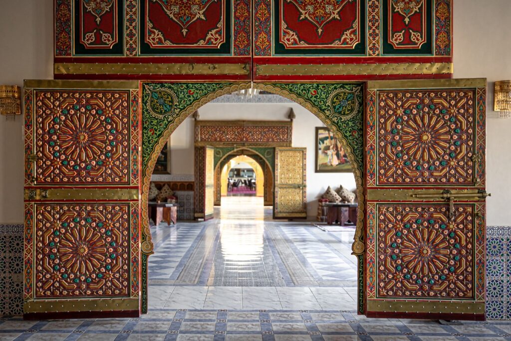 El mundo mudéjar: interior con arco ornamentado y puertas decoradas con motivos geométricos de tradición islámica.